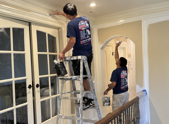 Ceiling and doorway trim being painted in a home interior